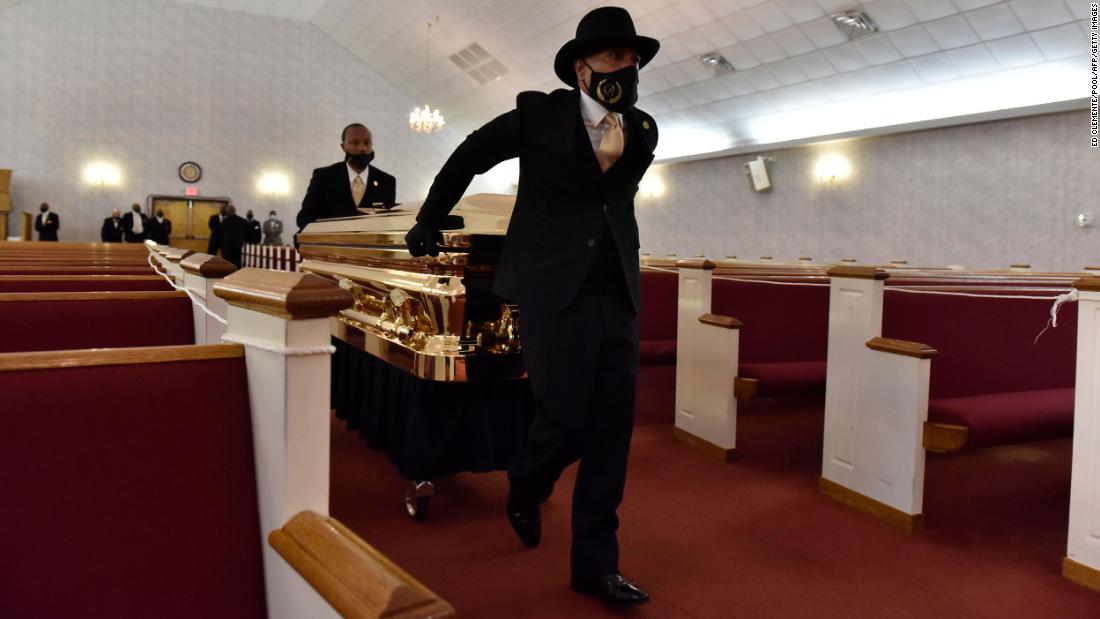 Floyd&#39;s casket is brought into a church ahead of his memorial service in Raeford.