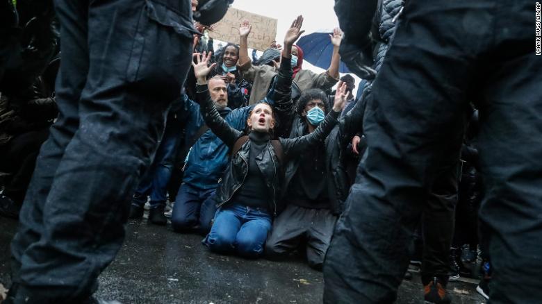 Demonstrators kneel facing police officers during another Black Lives Matter march in London on Saturday.