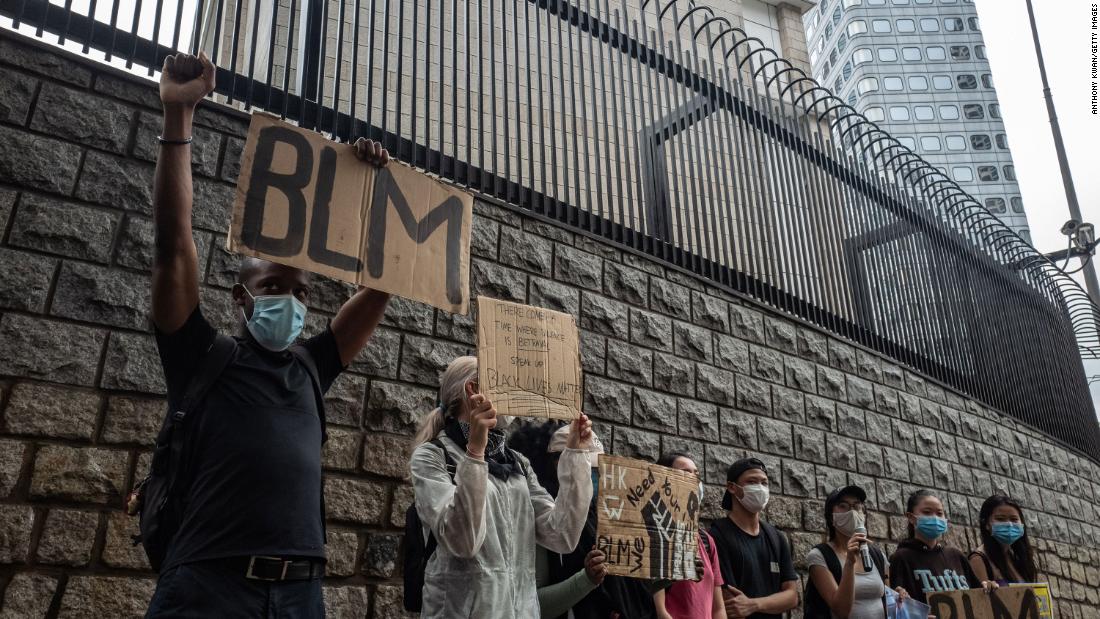 Participants hold signs during a rally outside of the Consulate General of the United States in Hong Kong on June 7.
