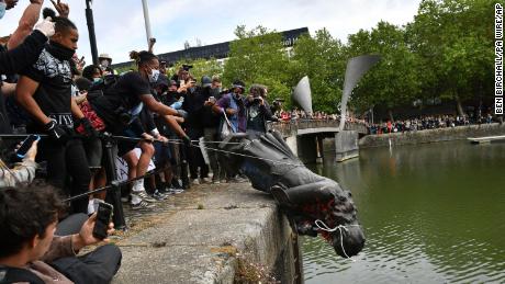 Black Lives Matter protests. Protesters throw statue of Edward Colston into Bristol harbour during a Black Lives Matter protest rally, in memory of George Floyd who was killed on May 25 while in police custody in the US city of Minneapolis. Picture date: Sunday June 7, 2020. See PA story POLICE Floyd. Photo credit should read: Ben Birchall/PA Wire URN:54052046 (Press Association via AP Images)