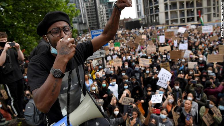 An activist addresses the crowd near the US Embassy in London.