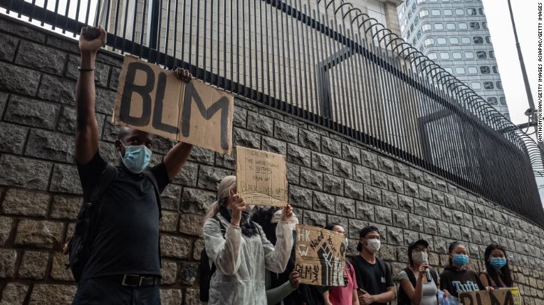 Small crowds gather outside the US Embassy in Hong Kong.