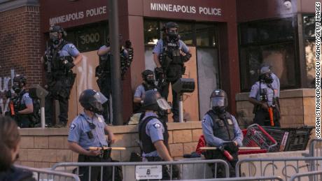 MINNEAPOLIS, USA - MAY 27: Police stand guard at protestors from the roof of the 3rd precinct on Wednesday, May 27, 2020, during the second day of protests over the death of George Floyd in Minneapolis. Floyd died in police custody in Minneapolis on Monday night, after an officer held his knee into Floyd&#39;s neck for more than 5 minutes. (Photo by Jordan Strowder/Anadolu Agency via Getty Images)