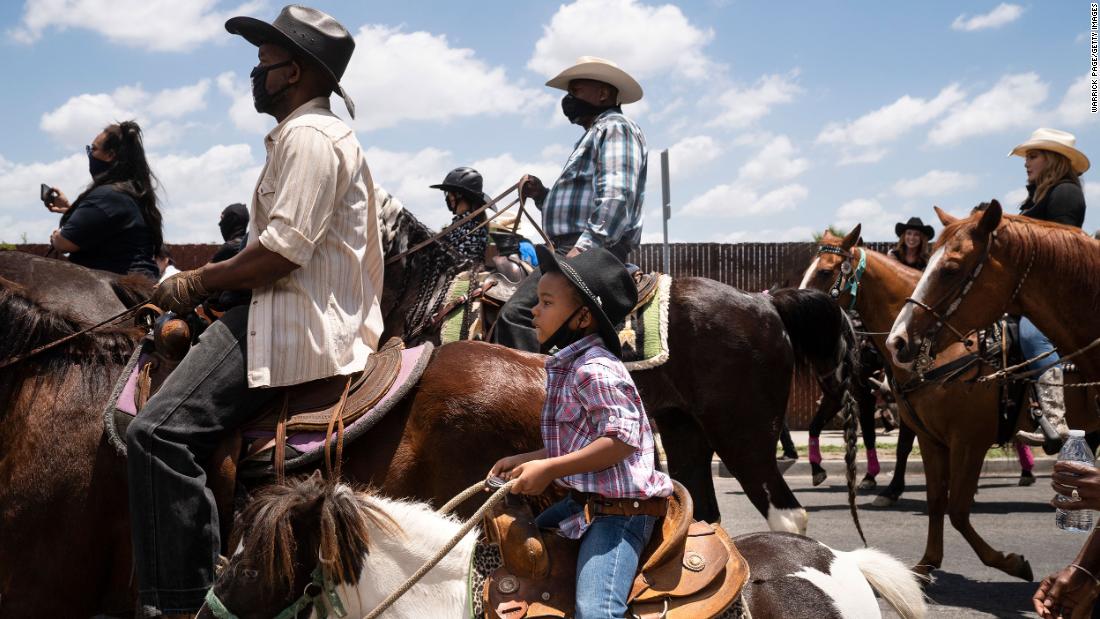 A young boy rides with the Compton Cowboys during a &quot;peace ride&quot; for George Floyd in Compton, California, on June 7.