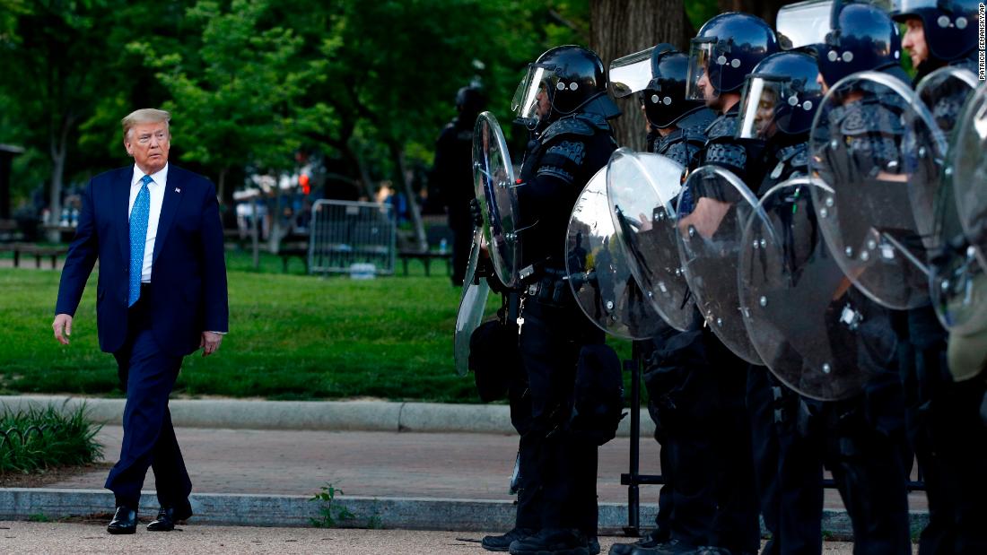 President Donald Trump walks past police in Lafayette Park after he visited St. John&#39;s Church across from the White House on Monday, June 1, 2020.