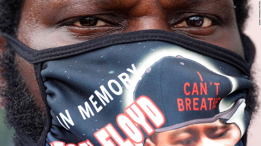 A man in Houston wears a mask honoring Floyd.