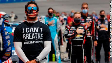 Bubba Wallace, the only full-time African American driver in NASCAR&#39;s Cup Series, wears a T-shirt that says &quot;I Can&#39;t Breathe&quot; and &quot;Black Lives Matter&quot; during the National Anthem before the NASCAR Cup Series Folds of Honor QuikTrip 500 at Atlanta Motor Speedway on June 7, 2020.