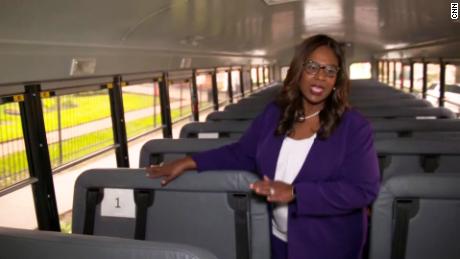 Interim Superintendent Grenita Lathan shows how children will be spaced while riding buses.