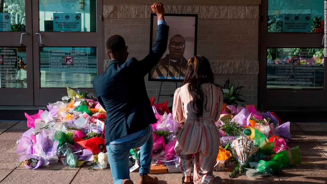 People pay their respects at a Floyd memorial in Houston on Tuesday.