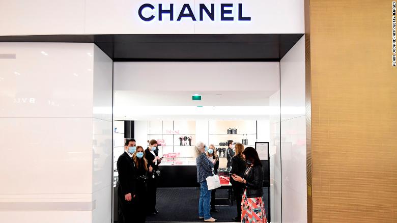 Shop assistants welcoming customers to Chanel at Galeries Lafayette, on the first day of the department store&#39;s reopening in Paris in May.