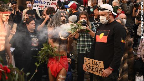 Aboriginal protesters perform a traditional smoking ceremony before the start of a Black Lives Matter demonstration in Sydney in June 2020.