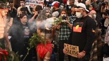 Aboriginal protesters perform a traditional smoking ceremony before the start of a Black Lives Matter demonstration in Sydney in June 2020.