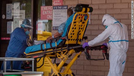 A patient is taken from an ambulance to the emergency room of a hospital in the Navajo Nation town of Tuba City.