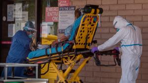 A patient is taken from an ambulance to the emergency room of a hospital in the Navajo Nation town of Tuba City during the 57 hour curfew, imposed to try to stop the spread of the Covid-19 virus through the Navajo Nation, in Arizona on May 24, 2020 - Weeks of delays in delivering vital coronavirus aid to Native American tribes exacerbated the outbreak, the president of the hard-hit Navajo Nation said, lashing the administration of President Donald Trump for botching its response. Jonathan Nez told AFP in an interview that of the $8 billion promised to US tribes in a $2.2 trillion stimulus package passed in late March, the first tranche was released just over a week ago. (Photo by Mark RALSTON / AFP) (Photo by MARK RALSTON/AFP via Getty Images)