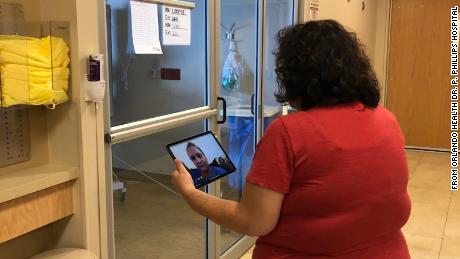 Chaplain Melinda Plumley can&#39;t visit coronavirus patients in their rooms and uses an iPad to communicate remotely.
