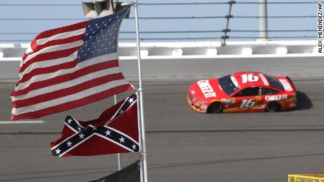 Sprint Cup Series driver Greg Biffle (16) speeds through turn 4 where a confederate flag is posted during the 57th Annual NASCAR Coke Zero 400 practice session at Daytona International Speedway on Friday, July 3, 2015 in Daytona Beach, Florida.  (AP Photo/Alex Menendez)