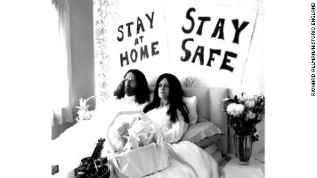  A tongue-in-cheek recreation of John Lennon and Yoko Ono&#39;s Bed-Ins for Peace, with the slogans &#39;Stay at Home&#39; and &#39;Stay Safe&#39;, taken during lockdown in Milton Keynes, England