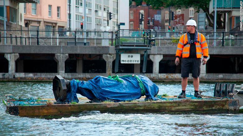 The statue of Edward Colston is recovered from the harbour in Bristol, England, on Thursday, June 11, after it was toppled by anti-racism protesters last weekend.