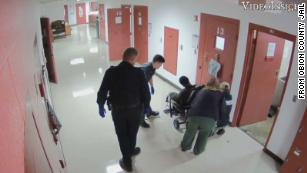 Officers place Sterling Higgins into a restraint chair in the Obion County Jail in Union City, Tennessee.