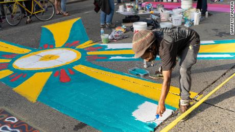 Local artists each took a letter of Black Lives Matter to creat a street mural.