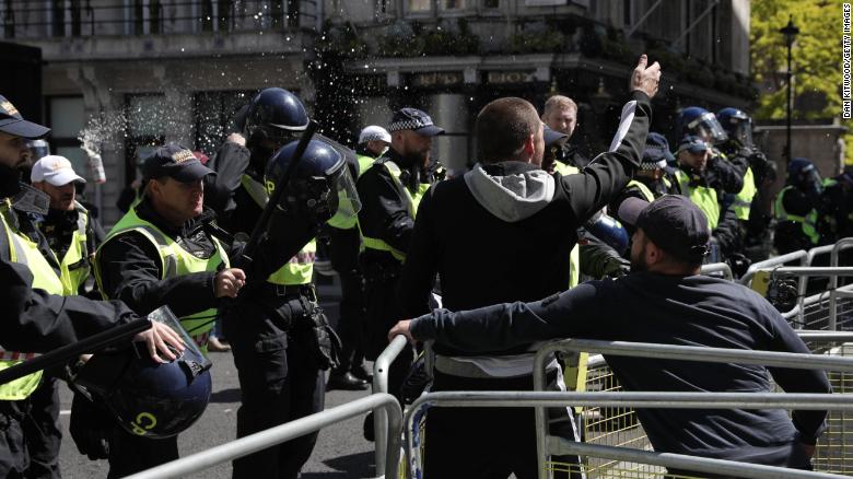 A can of beer is thrown at police officers as activists from far-right linked groups clash with police on Parliament Street as far-right groups gathered to &quot;protect&quot; statues in London.