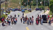 Protestors block University Avenue near the Wendy&#39;s restaurant in Atlanta on Saturday, June 13, 2020, where Rayshard Brooks, a 27-year-old black man, was shot and killed by Atlanta police Friday evening during a struggle in the restaurant&#39;s parking lot.