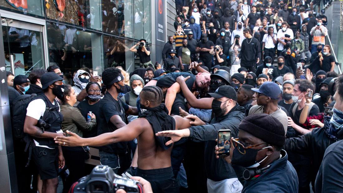 Black protester who carried injured white man through angry crowd says he was trying to avoid catastrophe