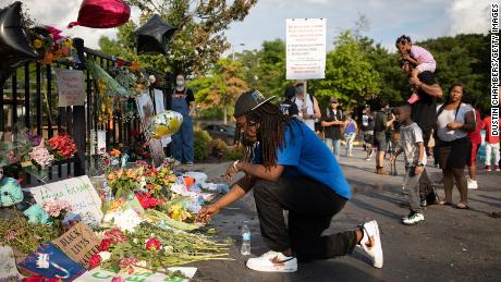 A man kneels at the memorial for Rayshard Brooks on June 14 in Atlanta.