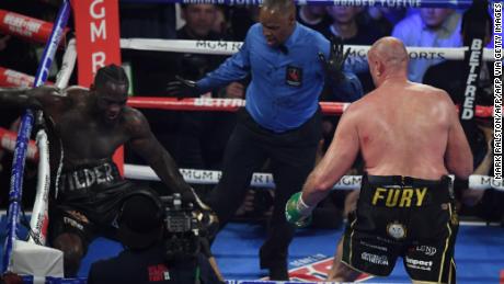 Fury knocks US boxer Deontay Wilder down before defeating him.