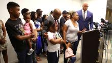 Tomika Miller, the wife of Rayshard Brooks, speaks in his memory with their children during a news conference on Monday