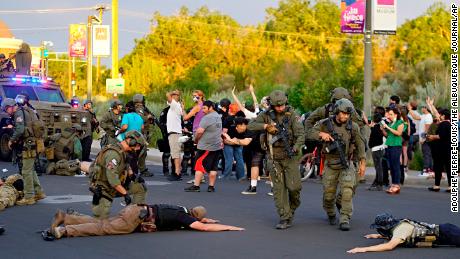 Albuquerque police detain members of the New Mexico Civil Guard, an armed civilian group, Monday, June 15, 2020, in Albuquerque, N.M. A confrontation erupted between protesters and a group of armed men who were trying to protect a statue of Spanish conquerer Juan de Oñate before protesters wrapped a chain around it and began tugging on it while chanting: &quot;Tear it down.&quot; One protester repeatedly swung a pickax at the base of the statue. Moments later a few gunshots could be heard down the street and people started yelling that someone had been shot. (Adolphe Pierre-Louis/The Albuquerque Journal via AP)