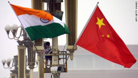 Workers put up the Indian flag (L) alongside the Chinese flag on Tiananmen Square in Beijing, 22 June 2003, ahead of Indian Prime Minister Atal Behari Vajpayee&#39;s arrival. Vajpayee&#39;s visit is the first to China by an Indian premier in a decade, as the two Asian giants which account for a third of the world&#39;s population, have had unsteady relations since a bloody 1962 border war, while fifteen rounds of talks since the 1980s have failed to resolve their boundary disputes.     AFP PHOTO (Photo by - / AFP) (Photo by -/AFP via Getty Images)