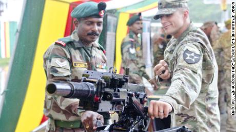 An Indian soldier showcases a grenade launcher to a US soldier on Sept. 15, 2016, at Chaubattia, India.