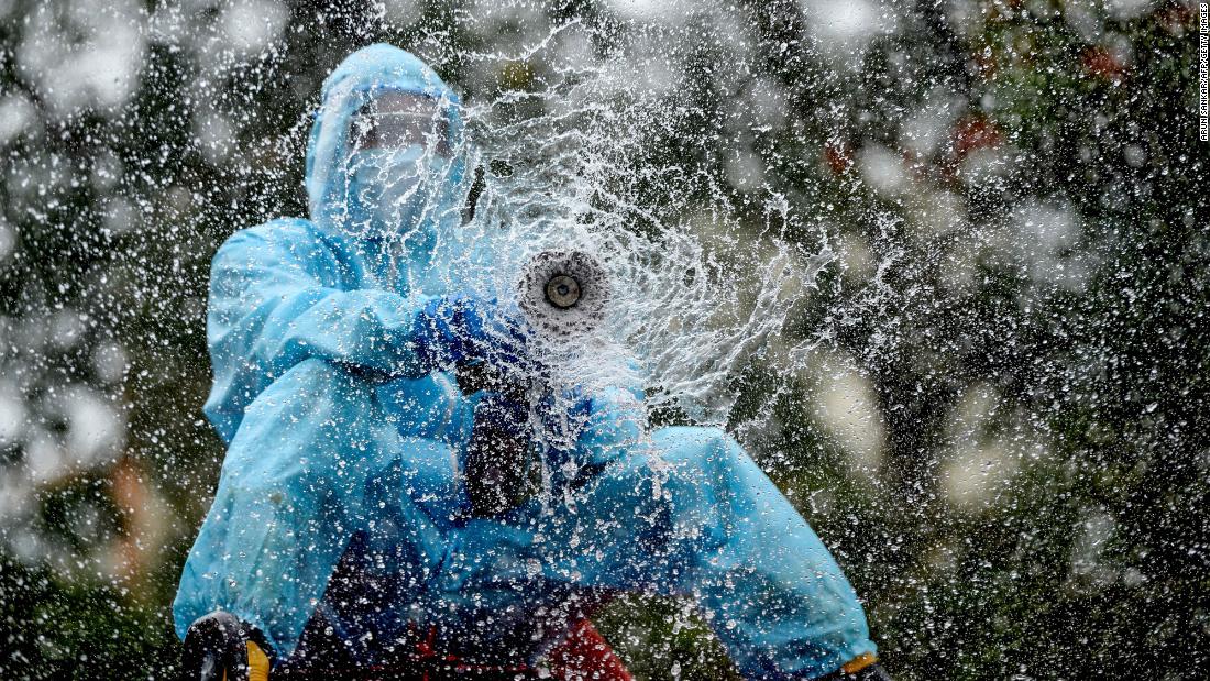 A firefighter in Chennai, India, sprays disinfectant to help prevent the spread of the coronavirus on June 11, 2020.