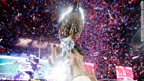 Members of the New England Patriots celebrate with the Vince Lombardi Trophy after defeating the Seattle Seahawks 28-24 in Super Bowl XLIX.