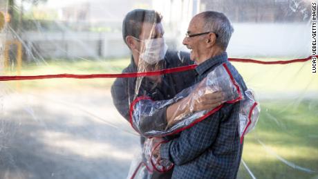 The &quot;hug tunnel&quot; allows the clinic&#39;s elderly residents to hug relatives after more than 70 days apart.