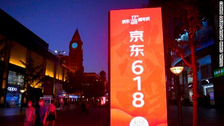 BEIJING, CHINA - JUNE 14: People walk by a JD.com advertisement of upcoming 618 Shopping Festival at Wangfujing Street on June 14, 2020 in Beijing, China. (Photo by VCG/VCG via Getty Images)