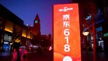 BEIJING, CHINA - JUNE 14: People walk by a JD.com advertisement of upcoming 618 Shopping Festival at Wangfujing Street on June 14, 2020 in Beijing, China. (Photo by VCG/VCG via Getty Images)