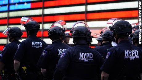 NYPD police officers watch demonstrators in Times Square on June 1, 2020, during a &quot;Black Lives Matter&quot; protest. - New York&#39;s mayor Bill de Blasio today declared a city curfew from 11:00 pm to 5:00 am, as sometimes violent anti-racism protests roil communities nationwide.
Saying that &quot;we support peaceful protest,&quot; De Blasio tweeted he had made the decision in consultation with the state&#39;s governor Andrew Cuomo, following the lead of many large US cities that instituted curfews in a bid to clamp down on violence and looting.