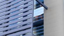 A detainee holds a sign  to the window of his Kangaroo Point hotel room: &quot;Thank you.&quot;