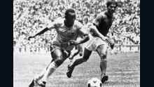 Pelé dribbles past Italian defender Tarcisio Burgnich, who later eulogized about the Brazil star.