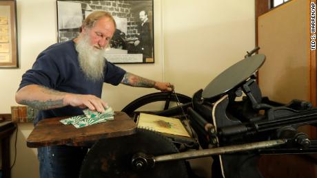  Loren Ackerman prints wooden money on an 1890s-era press in Tenino, Washington