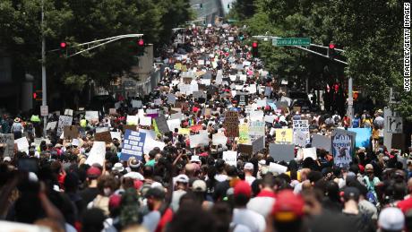 People march through the streets during a Juneteenth event Organized by the One Race Movement in Atlanta, Georgia.