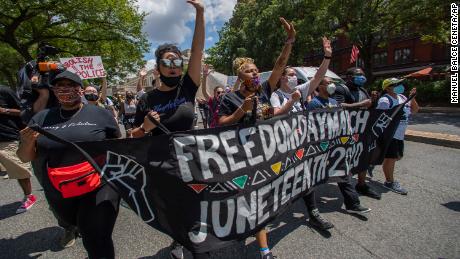 Protesters march towards the Martin Luther King Jr. Memorial in Washington on Friday, June 19, 2020, to mark Juneteenth, the holiday celebrating the day in 1865 that enslaved black people in Galveston, Texas, learned they had been freed from bondage, more than two years after the Emancipation Proclamation. (AP Photo/Manuel Balce Ceneta)