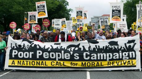 Demonstrators march during the Poor People&#39;s Campaign rally in Washington, DC, on June 23, 2018.