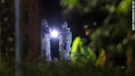 Forensic officers work at Forbury Gardens park where a summer-evening stabbing attack took place Saturday, in Reading, England, early Sunday June 21, 2020. (Steve Parsons/PA via AP)