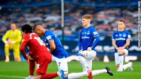 Players and officials take a knee in support of the Black Lives Matter movement before the Merseyside derby between Everton and Liverpool at Goodison Park. 