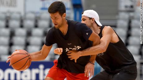 This photograph taken on June 18, 2020, shows Serbia&#39;s Novak Djokovic (L) and Bulgaria&#39;s Grigor Dimitrov, tennis players, as they take part in an exhibition basketball match in Zadar. - Croatia&#39;s Borna Coric announced on June 22, 2020, that he has become the second player to test positive for coronavirus after taking part in an exhibition tournament in Croatia featuring world number one Novak Djokovic. &quot;Hi everyone, I wanted to inform you all that I tested positive for COVID-19,&quot; the Croatian, ranked 33rd in the world, posted on Twitter. It follows the June 21, announcement by Grigor Dimitrov that he had also tested positive after pulling out of the exhibition event, which is one of the biggest since the tennis season was halted because of the pandemic. (Photo by STRINGER / AFP) / Croatia OUT (Photo by STRINGER/AFP via Getty Images)