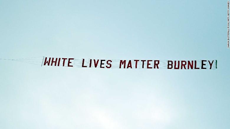 TOPSHOT - A banner reading &#39;White Lives Matter Burnley&#39; is towed by a plane above the stadium during the English Premier League football match between Manchester City and Burnley at the Etihad Stadium in Manchester, north west England, on June 22, 2020. (Photo by Shaun Botterill / POOL / AFP) / RESTRICTED TO EDITORIAL USE. No use with unauthorized audio, video, data, fixture lists, club/league logos or &#39;live&#39; services. Online in-match use limited to 120 images. An additional 40 images may be used in extra time. No video emulation. Social media in-match use limited to 120 images. An additional 40 images may be used in extra time. No use in betting publications, games or single club/league/player publications. /  (Photo by SHAUN BOTTERILL/POOL/AFP via Getty Images)