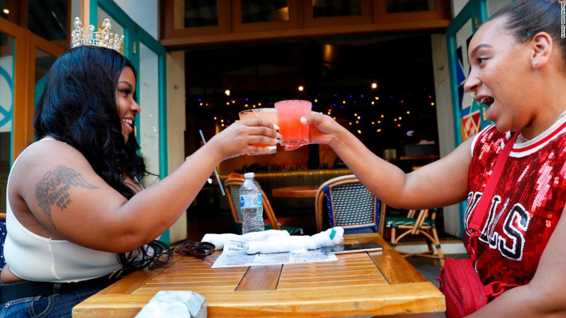 Maya Evans, right, toasts her friend Tifffany Webster&#39;s 30th birthday outside a restaurant in New York on June 22. The city &lt;a href=&quot;https://www.cnn.com/2020/06/22/health/us-coronavirus-monday/index.html&quot; target=&quot;_blank&quot;&gt;entered Phase Two of its reopening plan.&lt;/a&gt; Phase Two allows for outdoor dining and the opening of barbershops and salons. Retail stores can open for in-person shopping at 50% capacity.